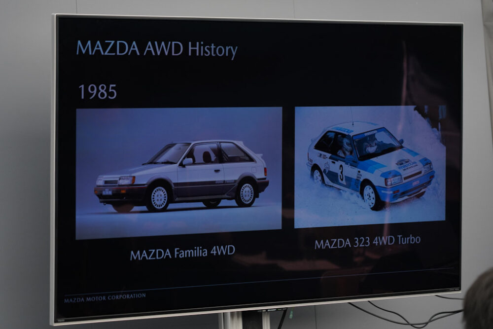 マツダ SUV オフロード試乗会プレゼンスライド。マツダAWDヒストリー。1985年、ファミリア4WD、323ターボ。
