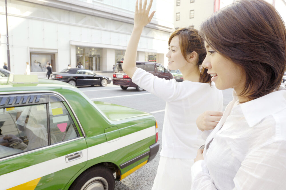 タクシーを停める女性