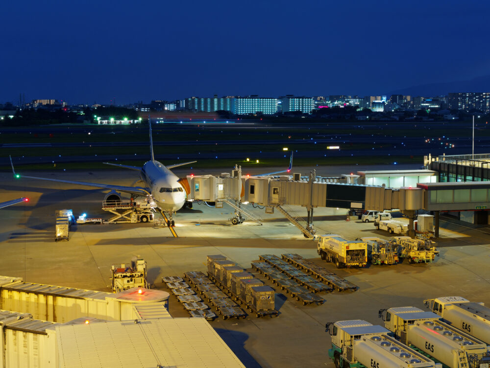 搭乗橋が繋がれた夜の飛行機